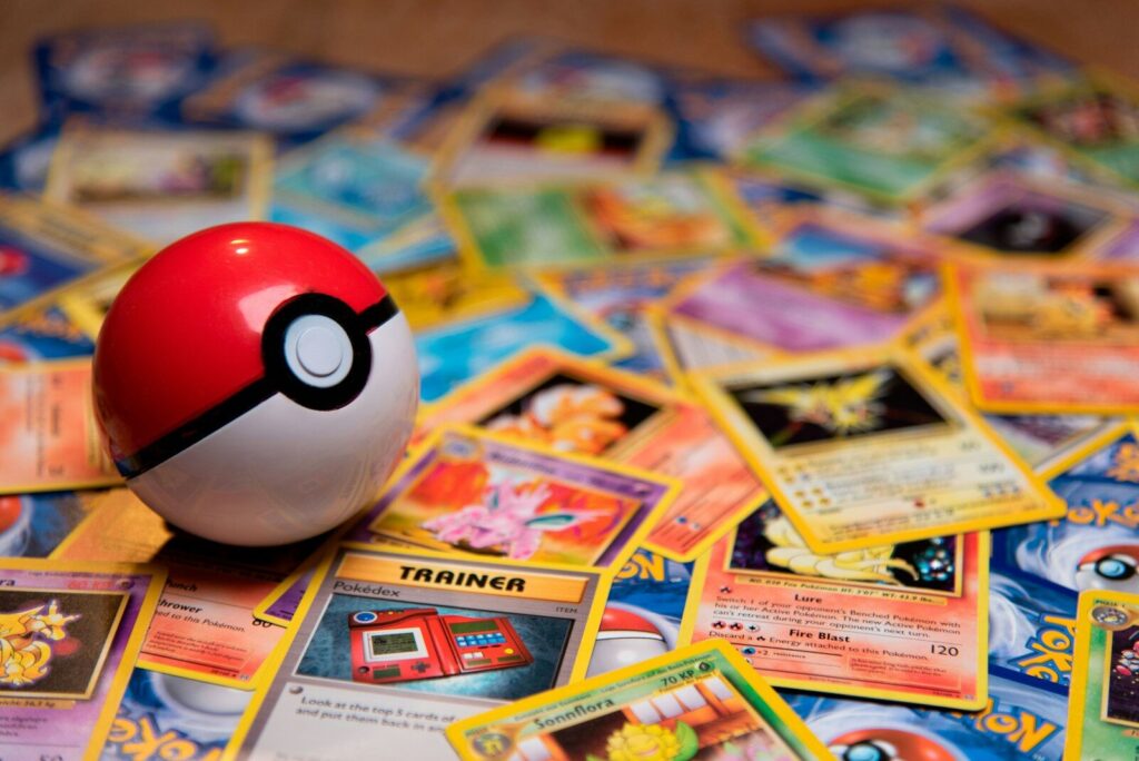 A red and white plastic ball resting on a pile of trading cards