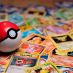 A red and white plastic ball resting on a pile of trading cards